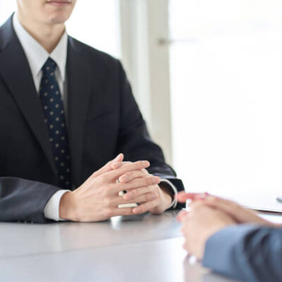 A man in a managerial position interviewing an employee